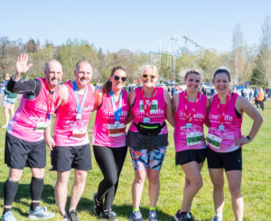 This picture shows a group of 4 females and 2 males celebrating after running a race for Newlife charity.