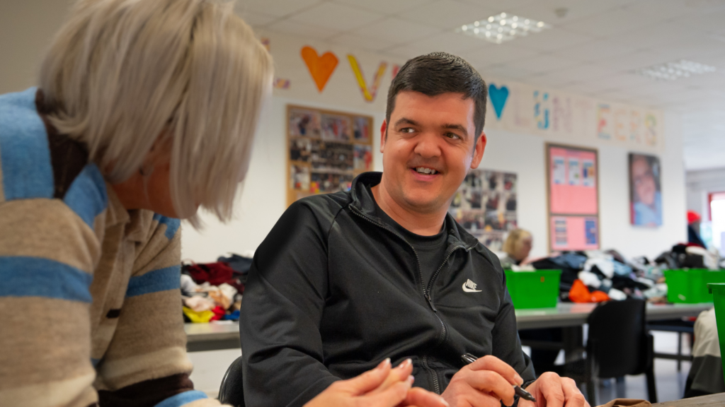 A volunteer manager and volunteer chatting and have a laugh in the Newlife opportunities centre