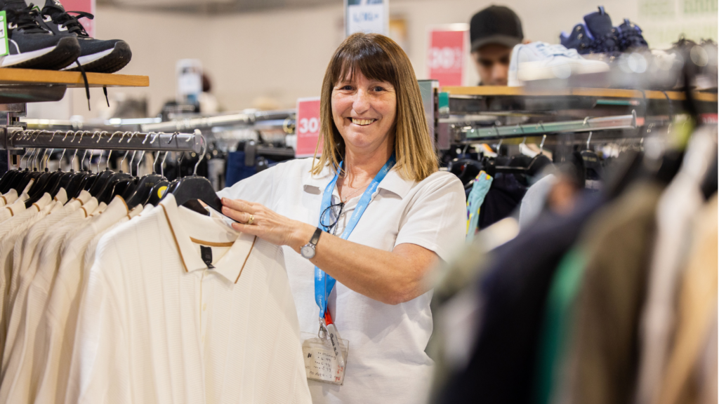Picture shows volunteer in a retail store setting for Newlife