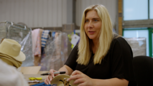 Picture shows a corporate volunteer in the Newlife warehouse processing stock