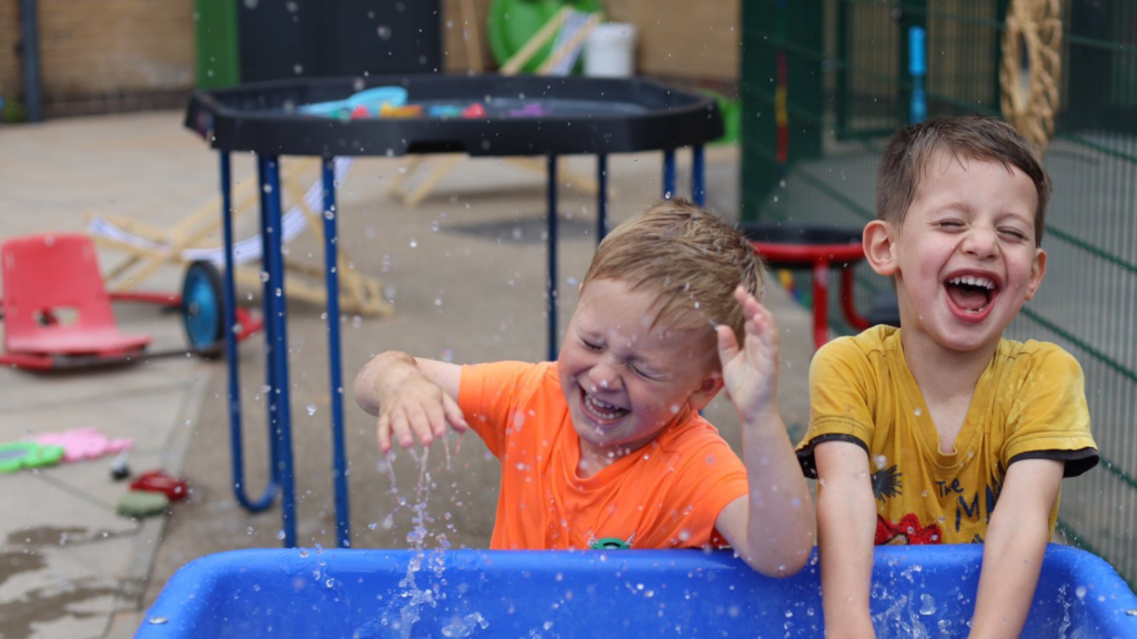 Boys playing with a water table
