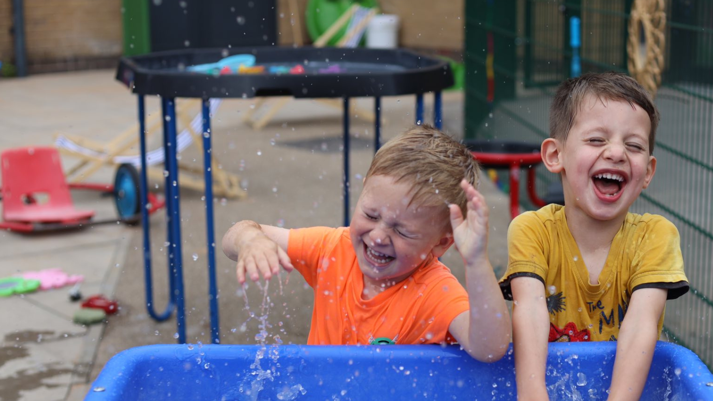 Boys playing with a water table